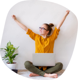 Photo of a woman sitting at her laptop and enjoying herself